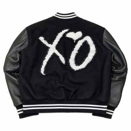 Black varsity jacket with a large white XO and heart graphic across the back.