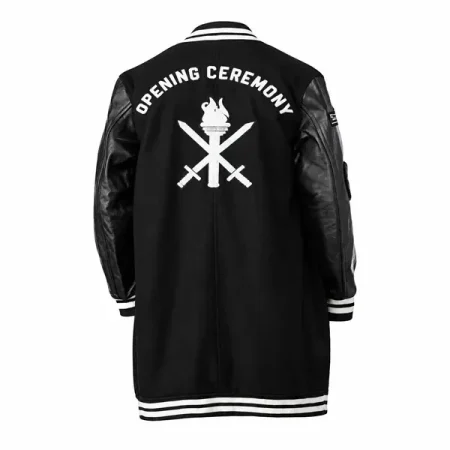 Back of a long black varsity coat with Opening Ceremony lettering, a white torch graphic and striped trim.